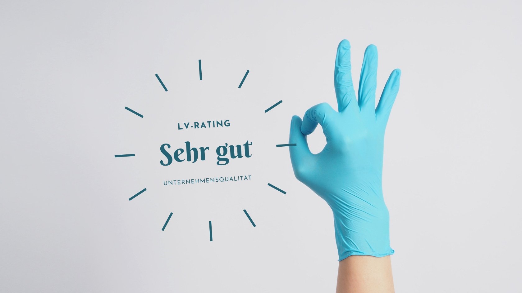 Hand mit türkisfarbenen Einweghandschuh. Daumen und Zeigefinger formen einen Ring, die anderen Finger sind nach oben gestreckt.